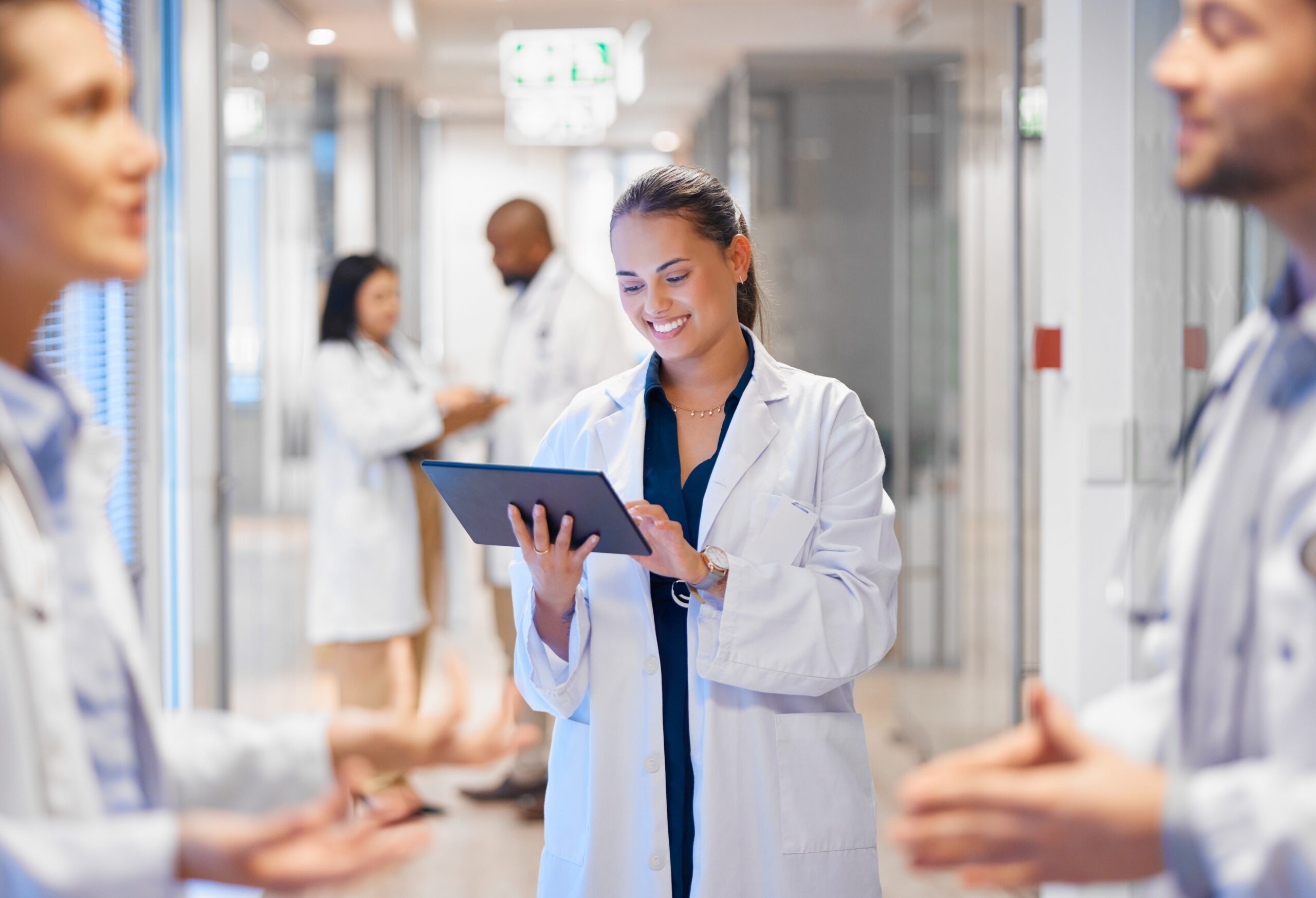 Happy,Woman,Doctor,On,Tablet,For,Employees,Management,,Hospital,Workflow